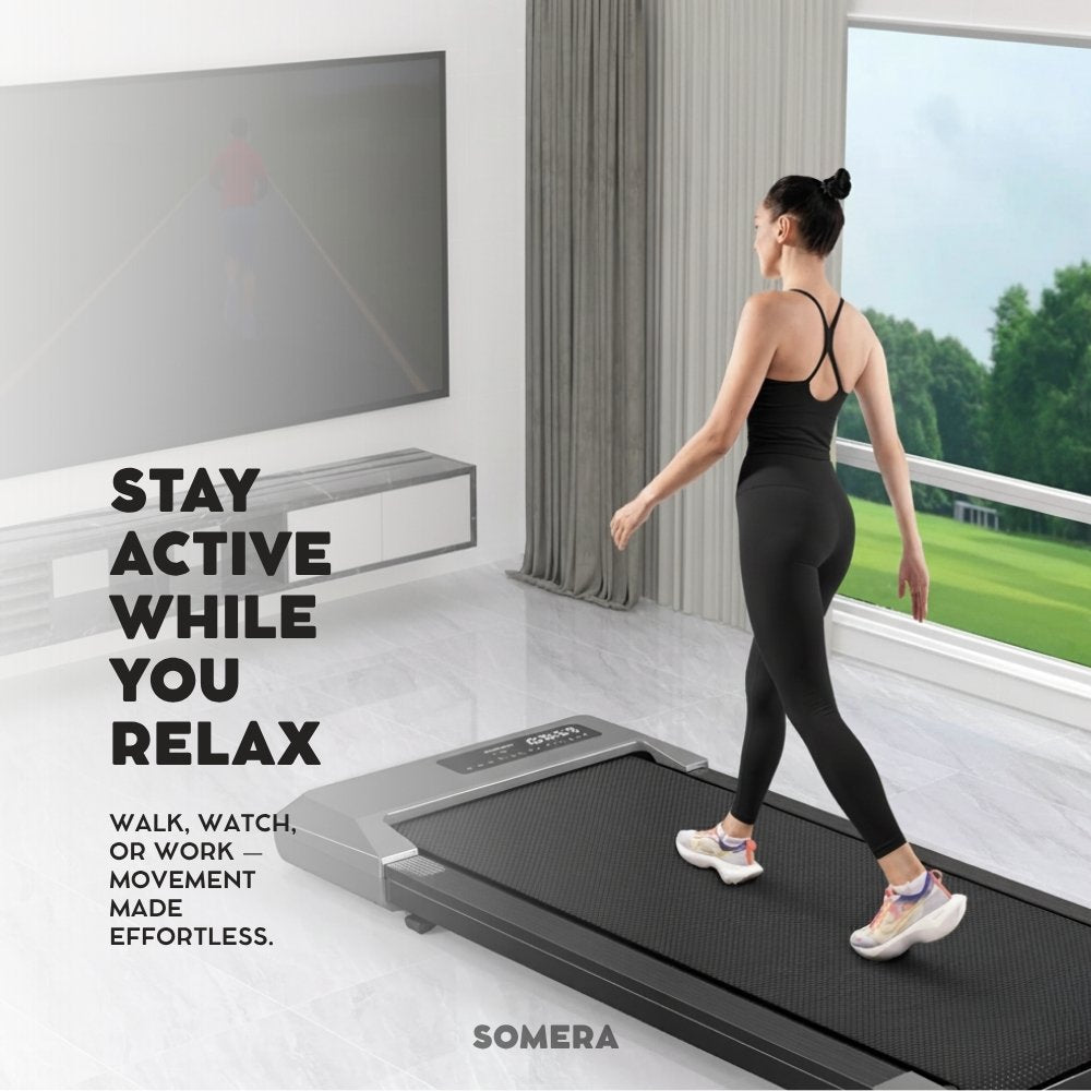 Woman walking on a treadmill walking pad in a modern room with a large window.